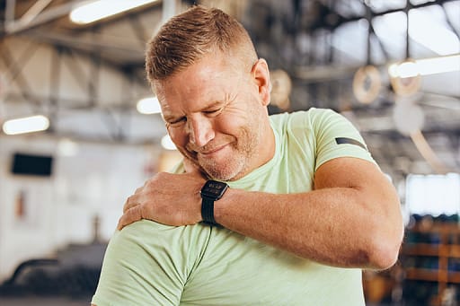 Action shot of a sports-related injury assessment at Kinesis Clinic for gym and exercise recovery.